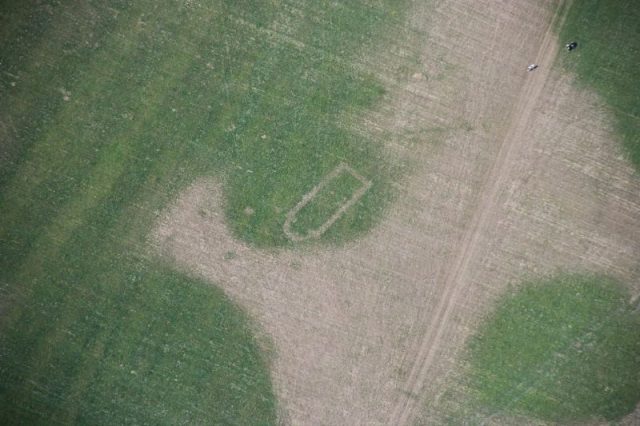 Aerial photograph of Llwydfaen Medieval Township, site of buried medieval church, view of parched foundations and wider township. Photo by Royal Commission on the Ancient and Historical Monuments of Wales (RCAHMW)