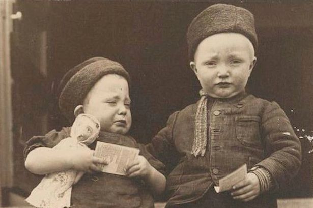 Dutch siblings from the Island of Marken, holding religious tracts.