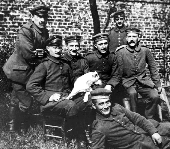 Hitler (far right, seated) with his army comrades of the Bavarian Reserve Infantry Regiment 16 (c. 1914–18). Photo by Bundesarchiv, Bild 146-1974-082-44 / CC-BY-SA 3.0