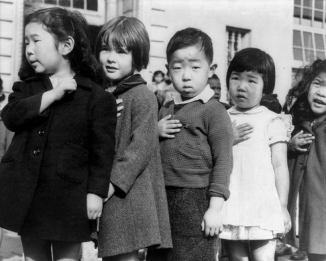 Children at the Weill public school in San Francisco pledge allegiance to the American flag in April 1942, prior to the internment of Japanese Americans.
