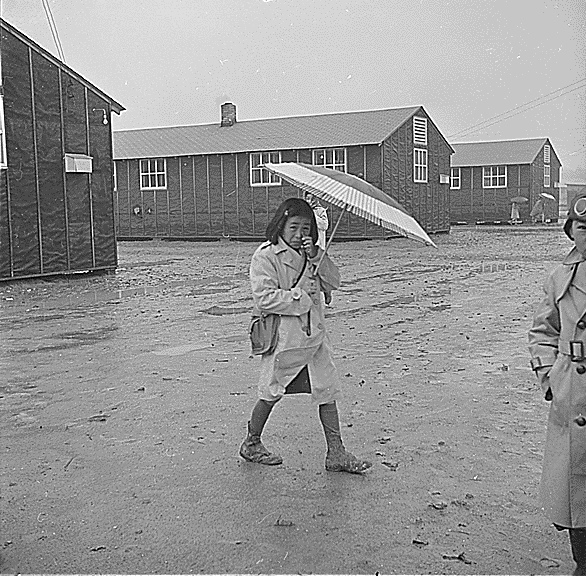 Trudging through the mud during rainy weather at the Jerome Relocation Center
