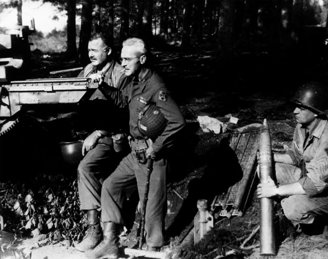 Ernest Hemingway and Colonel Charles T. “Buck” Lanham with captured artillery in Schweiler, Germany, 18 September 1944.