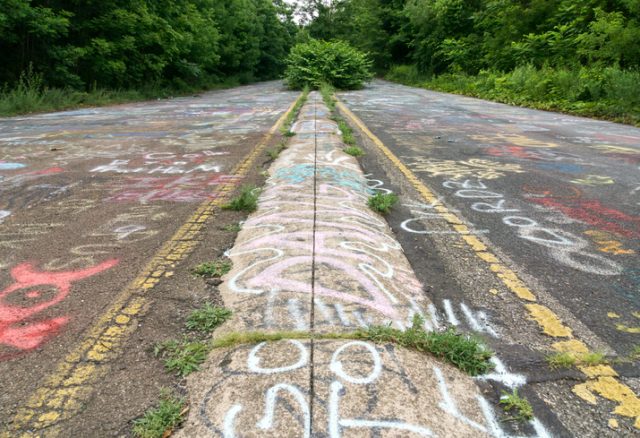 Centralia, USA, July 5, 2015. This image shows the center of the median strip and the yellow lines of PA 61, which is now overgrown and graffiti covered.