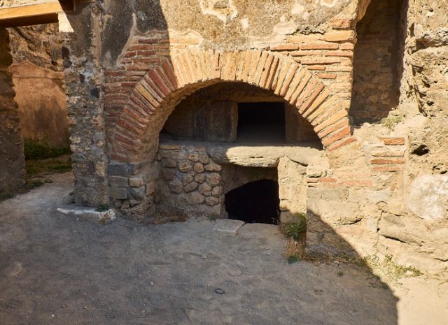 Roman bakery oven – archaeological remains at Ruins of Pompeii. The city was an ancient Roman city destroyed by the volcano Vesuvius. Pompeii, Campania, Italy.