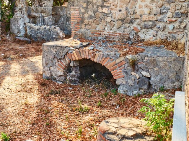 Roman kitchen of a Thermopolium in Via Consolare street at Ruins of Pompeii, Campania, Italy.