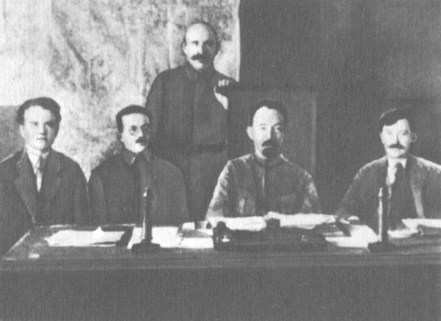 Members of the presidium of VCheKa (left to right) Yakov Peters, Józef Unszlicht, Abram Belenky (standing), Felix Dzerzhinsky, Vyacheslav Menzhinsky, 1921.