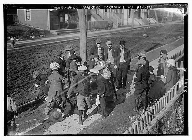 Thanksgiving Maskers scramble for pennies.