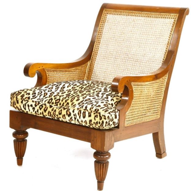 Teak lounge armchair with leopard print upholstery. Photo courtesy: Sworders