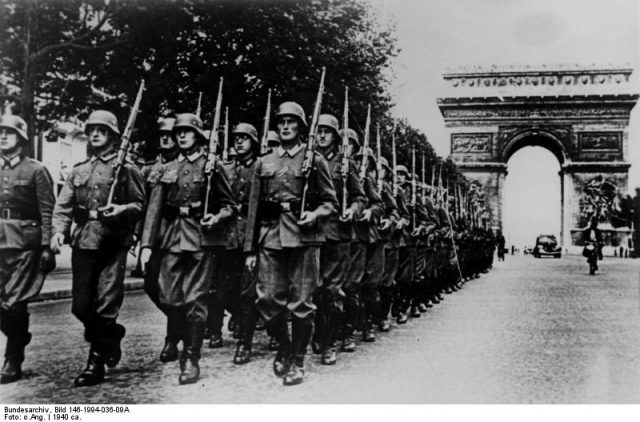 German soldiers parade on the Champs Élysées on June 14, 1940. Photo by Bundesarchiv, Bild 146-1994-036-09A / CC-BY-SA