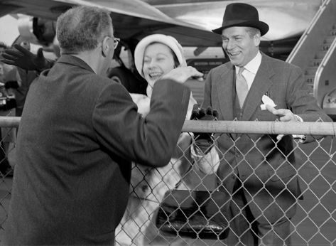 MGM film director George Cukor, greeting Laurence Olivier and his wife, actress Vivien Leigh, at airport in Los Angeles, California, 1957.