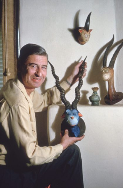 American author and illustrator Dr Seuss (Theodor Seuss Geisel, 1904 – 1991), holds the head of one of his characters in his home work room, La Jolla, California, April 25, 1957. Photo by Gene Lester/Getty Images