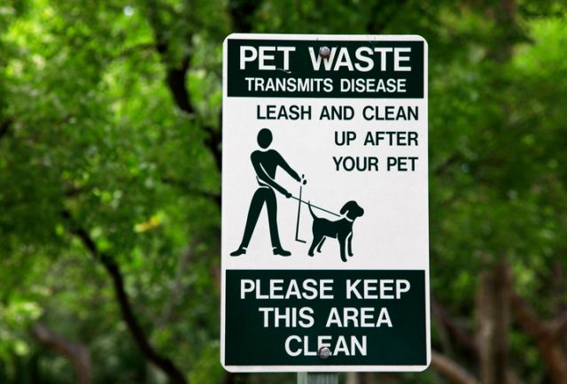 Pet waste sign at the park in Miami.