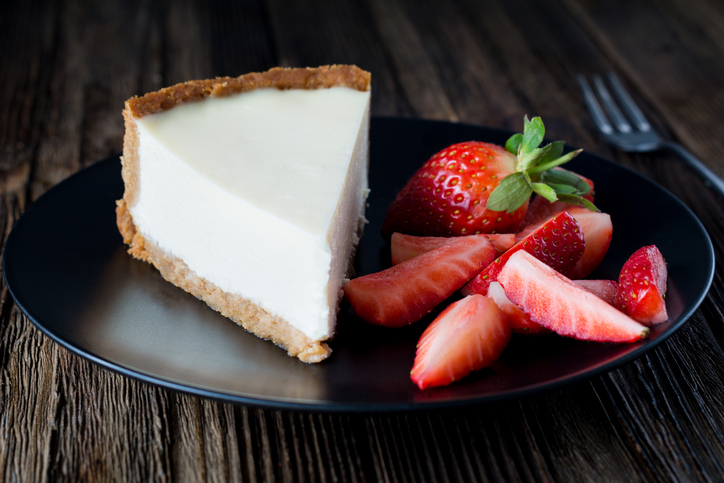 Plain New York cheesecake with fresh strawberries.