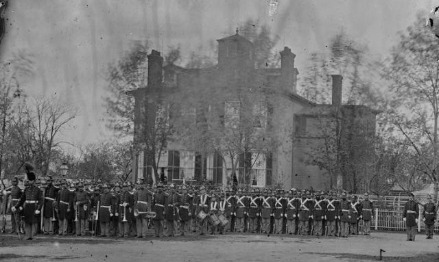 Marine battalion in front of Commandant’s House at the Marine Barracks in 1864.