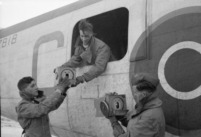 Crewmen of Consolidated Liberator GR Mark VA, BZ818 ‘C’, of No. 53 Squadron RAF handling carriers containing homing pigeons at St Eval, Cornwall.