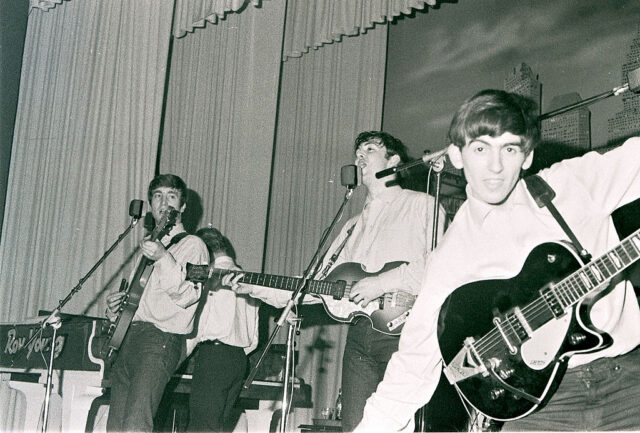 The Beatles performing on stage