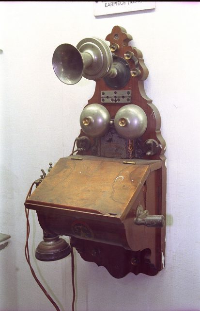 Wooden wall telephone with a hand-cranked magneto generator. Photo by Biswarup Ganguly CC BY 3.0