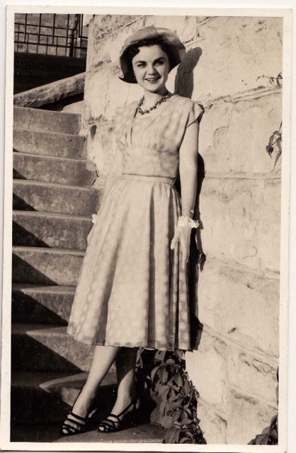 Cute girl in a sun dress. The gloves date her outfit, but the printed dress and neat heels still look modern today.