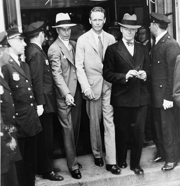 Charles A. Lindbergh after telling the grand jury his story of the payment of $50,000 ransom for his son. At the right is Colonel H. Norman Schwarzkopf, of the New Jersey State Police, who accompanied Colonel Lindbergh.