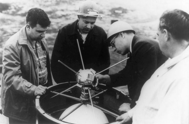 A team of Vanguard I scientists mount the satellite in the rocket.