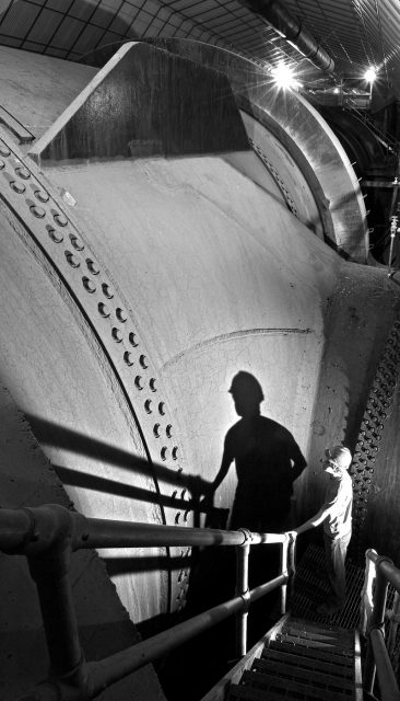 A worker stands by the 30 ft (9.1 m) diameter Nevada penstock before its junction with another penstock that delivers water to a turbine. Photo by Jeffrey G. Katz CC BY 3.0
