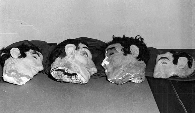 Four papier-mâché human heads lined up