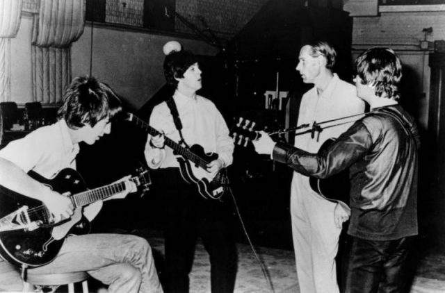 George Harrison, Paul McCartney and John Lennon with George Martin at EMI Studios in the mid 1960s.