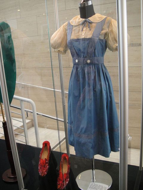 Judy Garland “Dorothy Gale” Arabian-pattern test “Ruby Slippers” and dress with blouse from The Wizard of Oz (1939) at the Debbie Reynolds Auction. All were early concept designs that were not used in the final film. Photo by Doug Kline CC BY 2.0