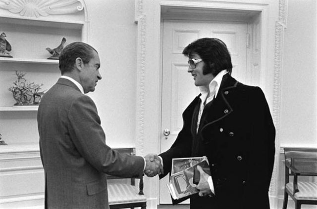 Elvis Presley and Richard Nixon shaking hands.