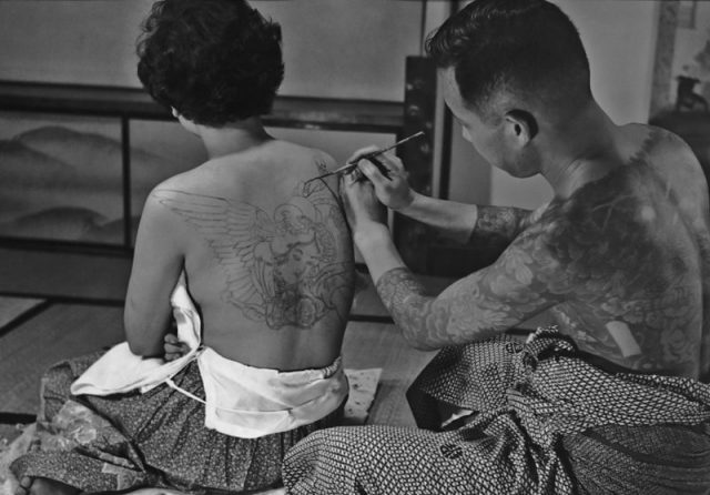 Tattoo artist Horigoro at work on a design on a woman’s back in Japan in 1955. Photo by FPG/Getty Images