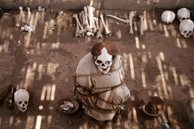 Mummy and human bones at Chauchilla ancient cemetery in Peru.