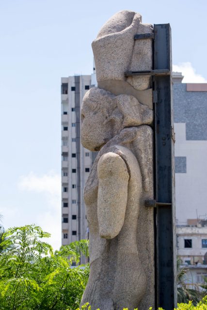 The ancient statue positioned in front of the Library of Alexandria (aka Bibliotheca Alexandrina or Maktabat al-Iskandarīyah) evoking the spirit of the original library. Alexandria, Egypt – July 19, 2016.