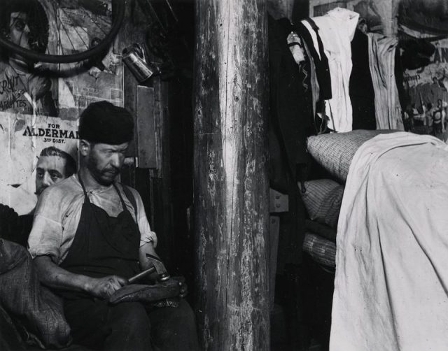 Shoemaker working in a house in the yard of 219 Broome Street, which the landlord built when the Sanitary Police put him out of the basement.