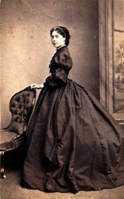 Young woman in black dress, 1860s.