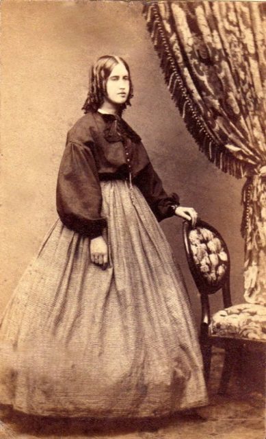 Girl posing next to a chair