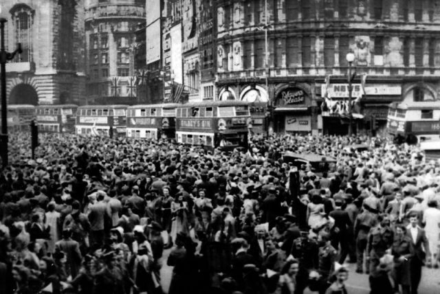 Crowds gathering in celebration at Piccadilly Circus during VE Day in 1945.