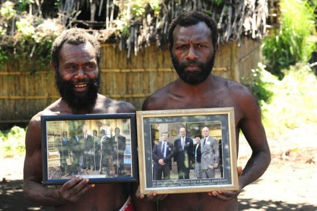 Yaohnanen tribesmen show pictures of 2007 visit with Prince Philip. Photo by Christopher Hogue Thompson CC BY-SA 3.0