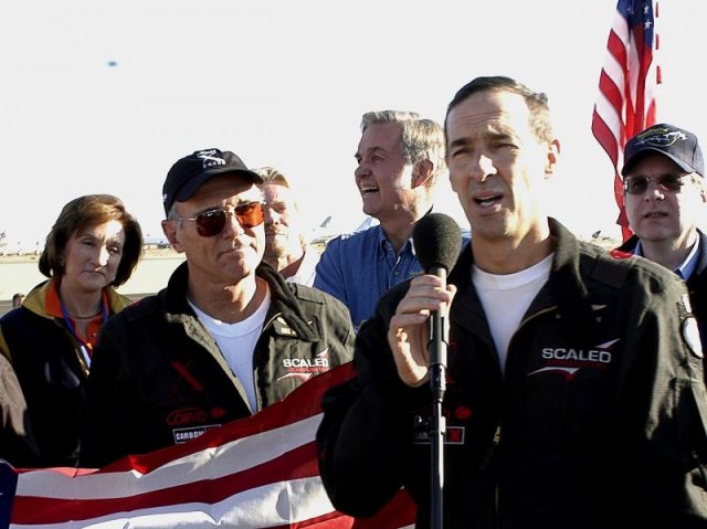 (L-R) Marion Blakey, Mike Melvill, Sir Richard Branson, Burt Rutan, Brian Binnie and Paul G. Allen reflect on a mission accomplished in 2004. Photo by D Ramey Logan CC BY-SA 3.0