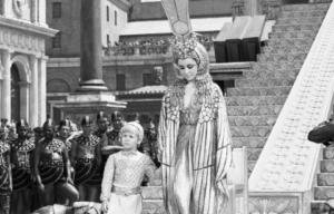 Elizabeth Taylor as Cleopatra holding hands with her "son," Caesarion.