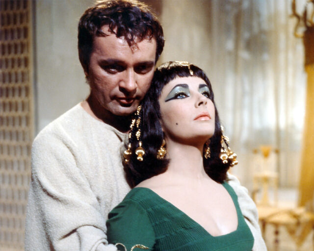 Richard Burton embraces Elizabeth Taylor from behind as they play Mark Antony and Cleopatra.