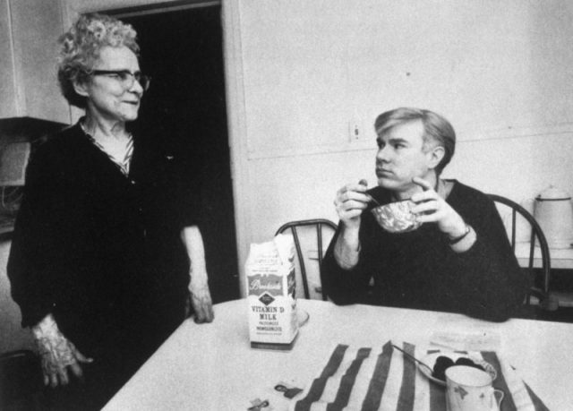 Pop artist Andy Warhol eating cereal and looking at his mother Julia, prob. at her home. (Photo by Ken Heyman/Woodfin Camp/Woodfin Camp/The LIFE Images Collection/Getty Images)