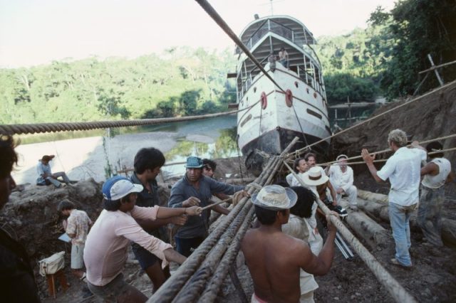 Filming on the set of Fitzcarraldo, directed by Werner Herzog, on location in Peru. Crew members hauling the paddle steamer. Photo by jean-Louis Atlan/Sygma via Getty Images