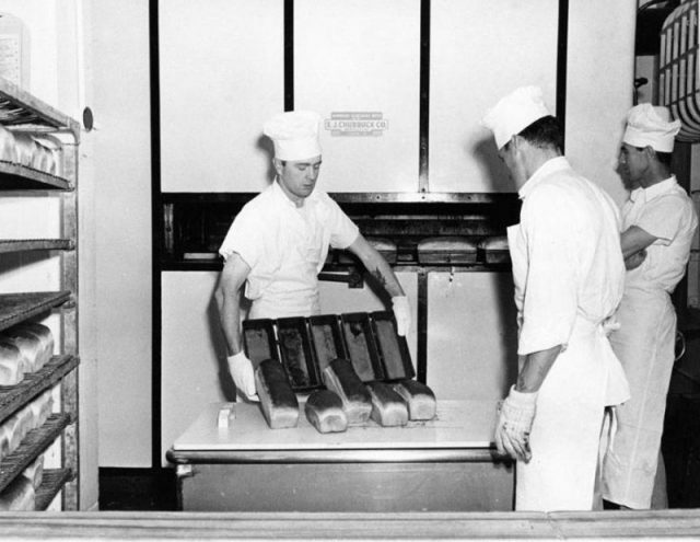 Inmates bake bread in the prison kitchen.