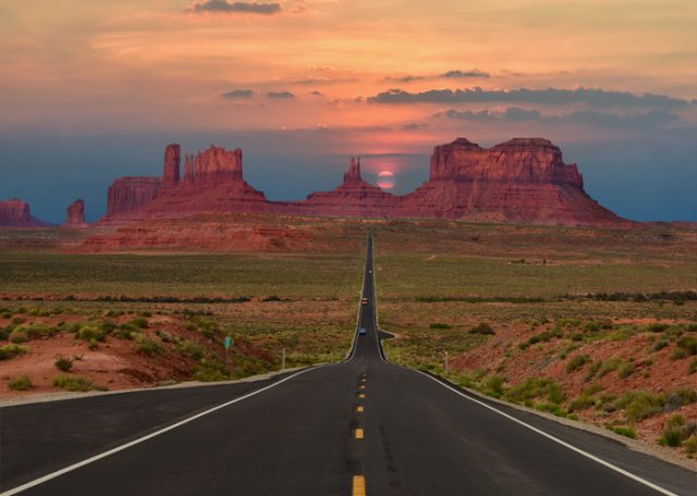 Beautiful scenic highway in Monument Valley Tribal Park in Arizona-Utah border, U.S.A. at sunset.