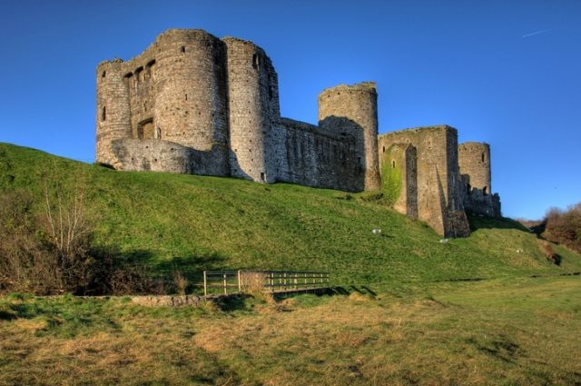 Kidwelly Castle and clear blue sky.