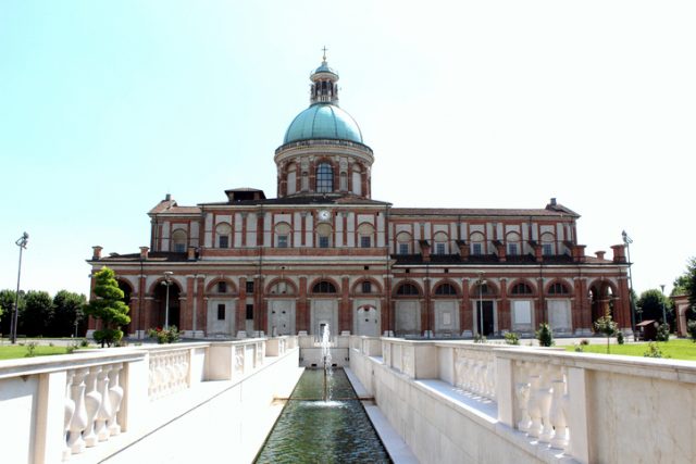 Sanctuary of Caravaggio church and fountain, side view from square. Cathedral construction began in 1575. The Sanctuary of Our Lady of Caravaggio is open all year round. The entry is free. Caravaggio, Italy.