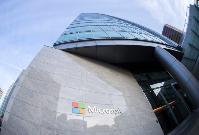 February 10, 2018 – Bellevue, WA, USA: A Microsoft sign can be seen at the entrance of a glass building on a sunny day