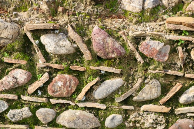 Detail of unusual ancient rock wall design and pattern in Olympia, Greece where the first Olympics were held.