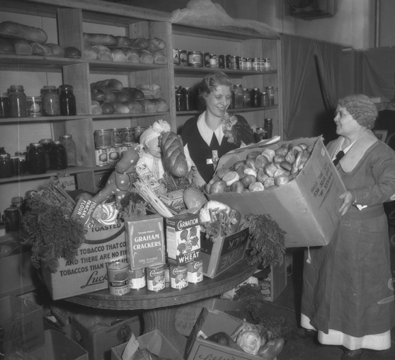 McPherson (left) prepares Christmas food baskets, c. 1935.