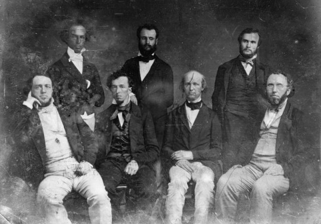 New-York Tribune editorial staff. Greeley is third from the left in the front row.